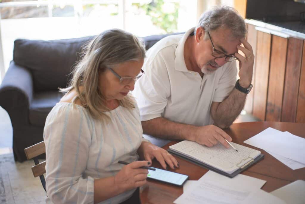 Couple reviewing paperwork and finances together at home