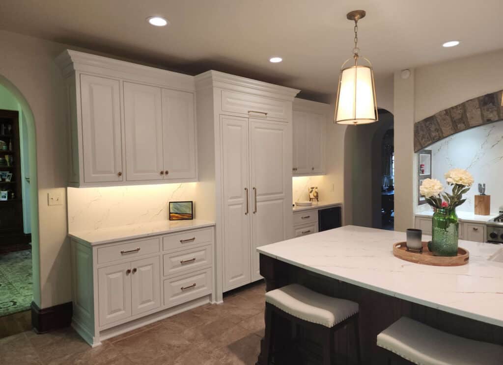 White custom kitchen cabinets with quartz countertops and a large island in The Villages, Florida